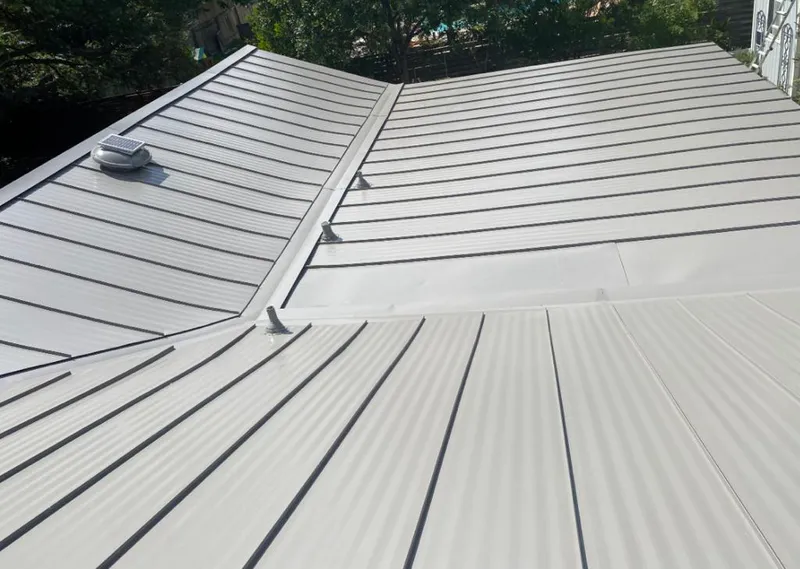 Solar attic fan installed on a metal roof for Roof Ventilation in DuPont
