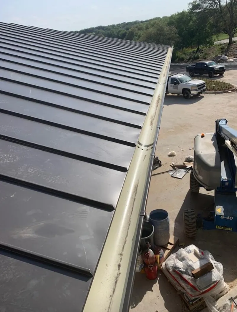 Standing seam panel and gutter detail on a metal roofing jobsite in DuPont